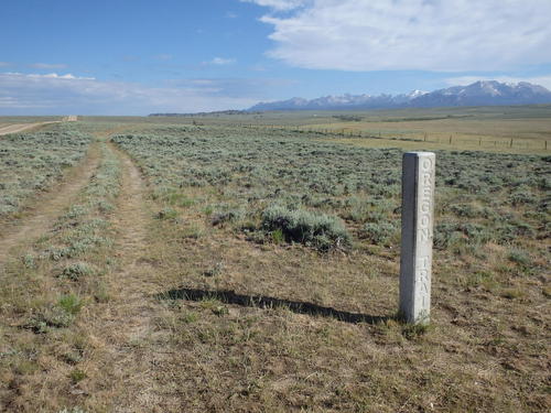 GDMBR: An Oregon Trail Marker and an old wagon wheel track parallels our road of travel.